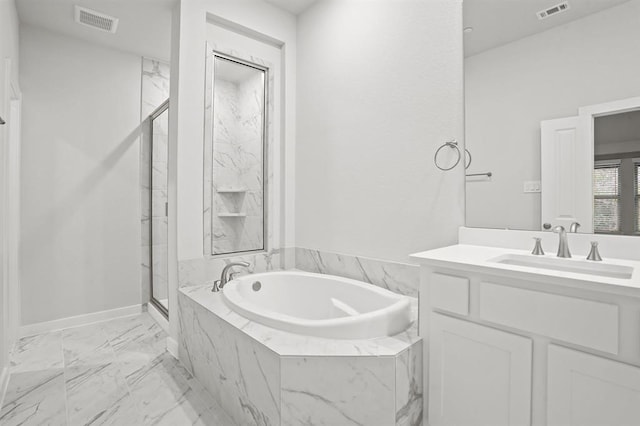 bathroom featuring vanity and shower with separate bathtub