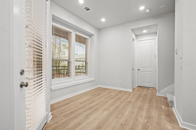 unfurnished room with light hardwood / wood-style flooring