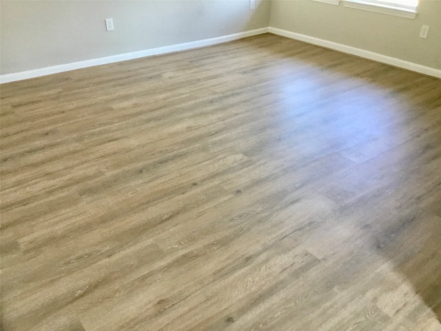 unfurnished room featuring hardwood / wood-style flooring