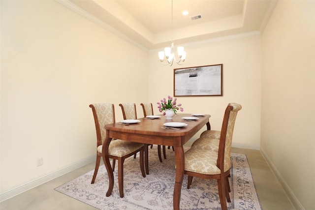 dining room with a chandelier, crown molding, and a tray ceiling