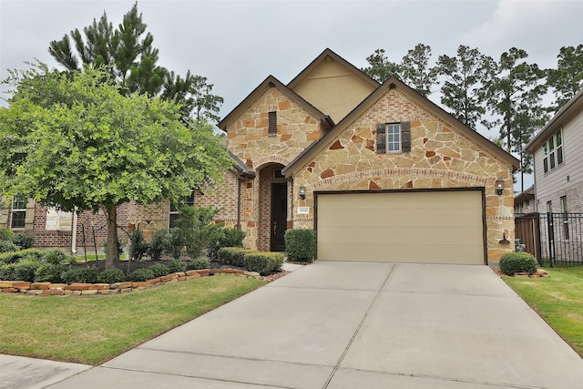 english style home with a front yard and a garage