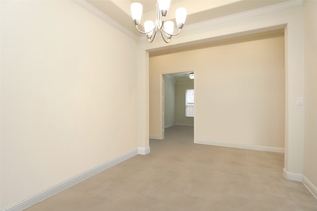 empty room featuring an inviting chandelier and crown molding