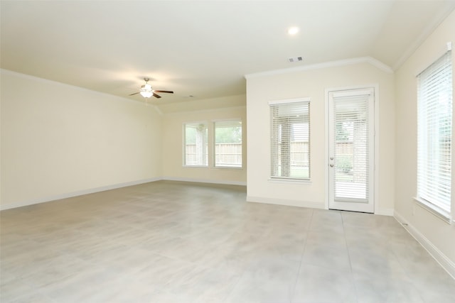 empty room with crown molding, lofted ceiling, and plenty of natural light