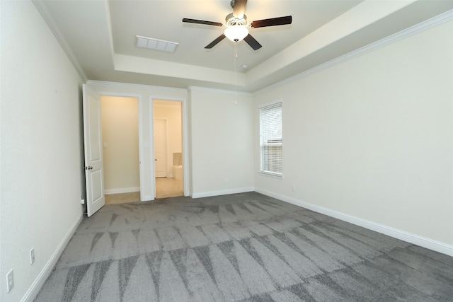 unfurnished bedroom with ceiling fan, a raised ceiling, ornamental molding, and light carpet