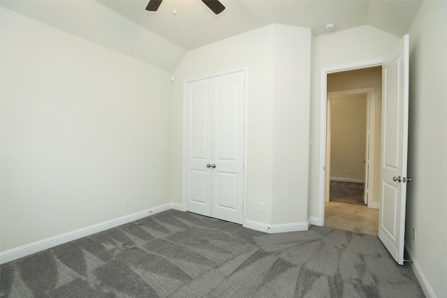 unfurnished bedroom featuring a closet, lofted ceiling, carpet, and ceiling fan