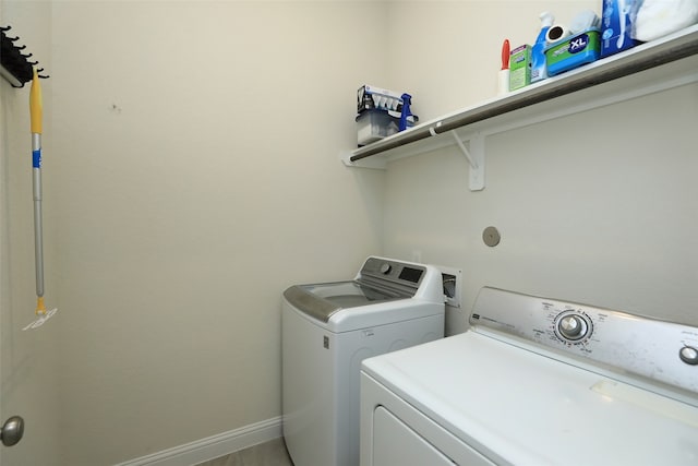 clothes washing area with separate washer and dryer