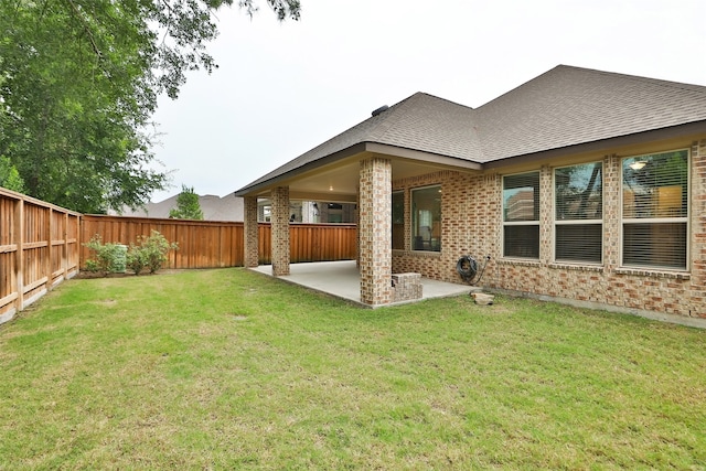 rear view of property with a patio area and a lawn