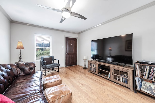 living room with light hardwood / wood-style flooring, ornamental molding, and ceiling fan