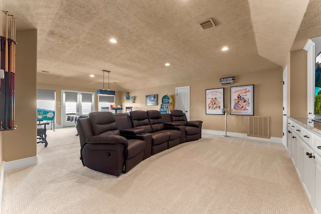 carpeted cinema with a textured ceiling