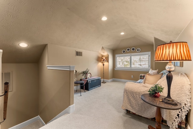 living area featuring light carpet, a textured ceiling, and vaulted ceiling