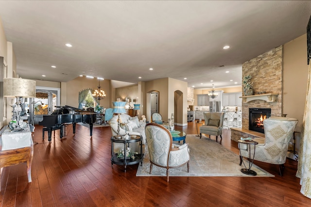 living room with hardwood / wood-style floors and a stone fireplace