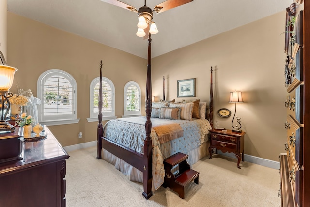 bedroom featuring light colored carpet and ceiling fan