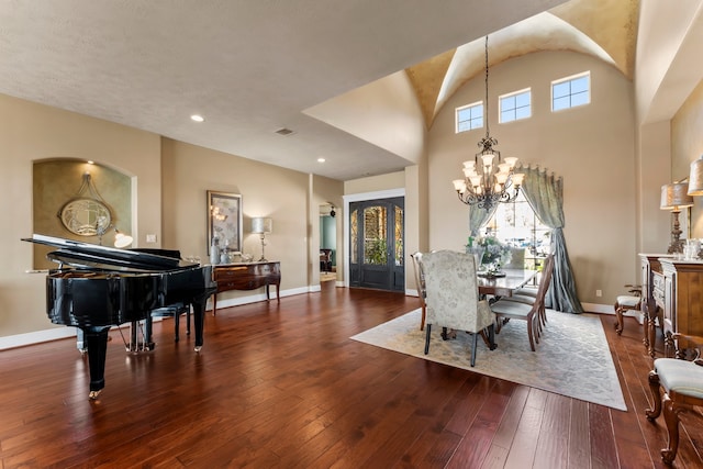 dining room featuring an inviting chandelier, wood-type flooring, and plenty of natural light