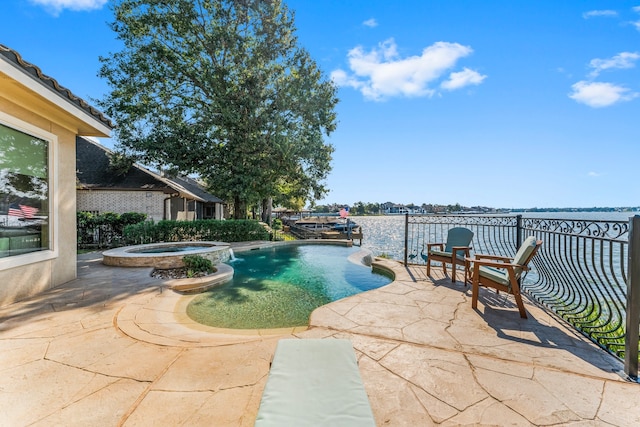 view of pool with a patio area and an in ground hot tub