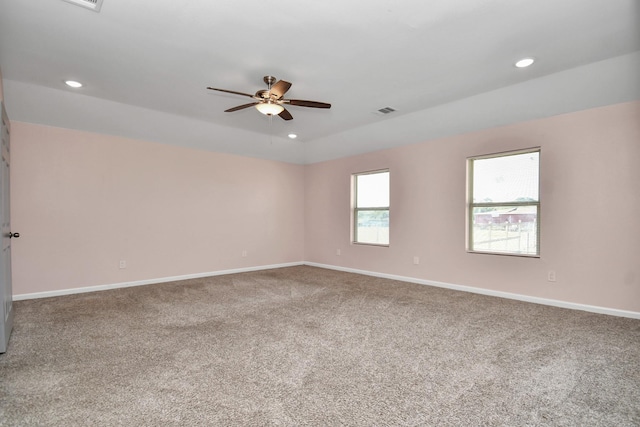 carpeted spare room with ceiling fan