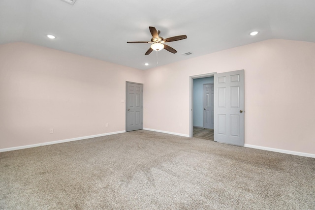 spare room with ceiling fan, carpet, and vaulted ceiling