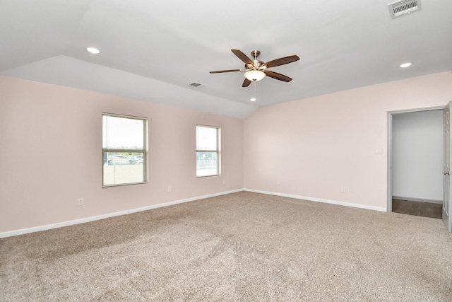 carpeted empty room with ceiling fan and vaulted ceiling