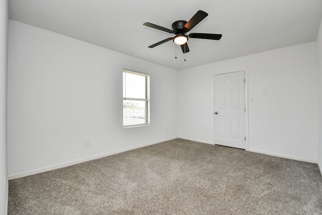 spare room featuring ceiling fan and carpet floors