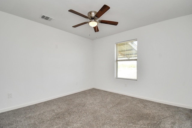 carpeted empty room featuring ceiling fan