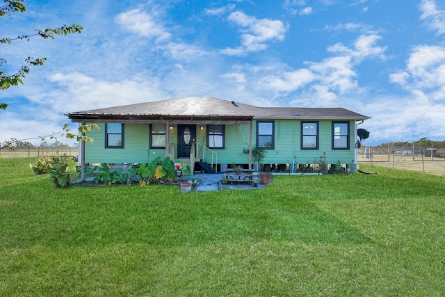 rear view of house featuring a lawn