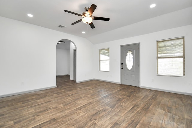 foyer entrance featuring ceiling fan, dark hardwood / wood-style floors, and vaulted ceiling