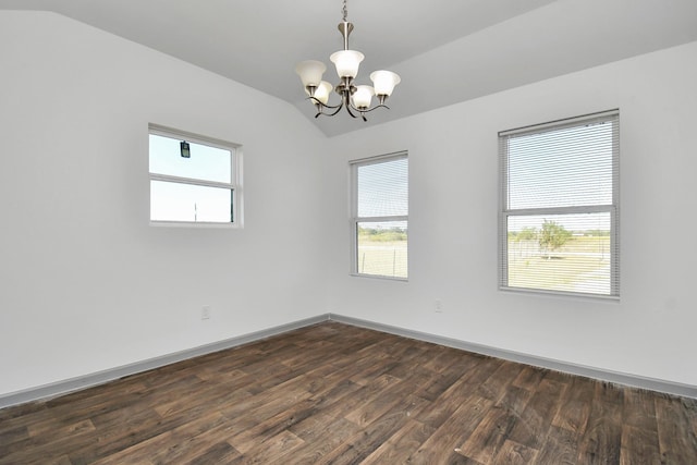 unfurnished room with an inviting chandelier, vaulted ceiling, and dark hardwood / wood-style floors