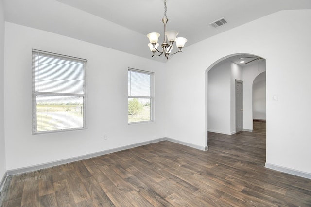 spare room featuring dark hardwood / wood-style flooring, lofted ceiling, and a chandelier