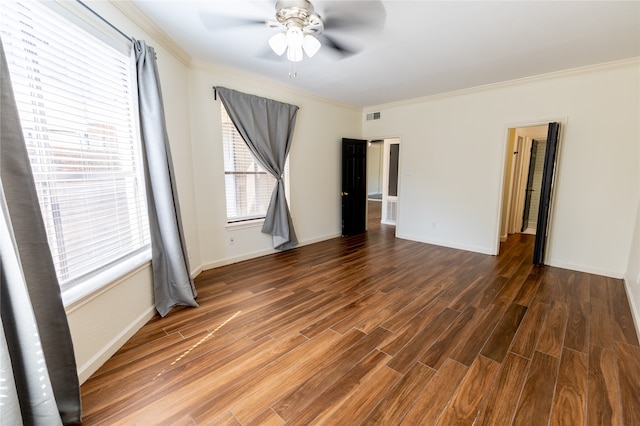 unfurnished room featuring ceiling fan, dark hardwood / wood-style flooring, and crown molding