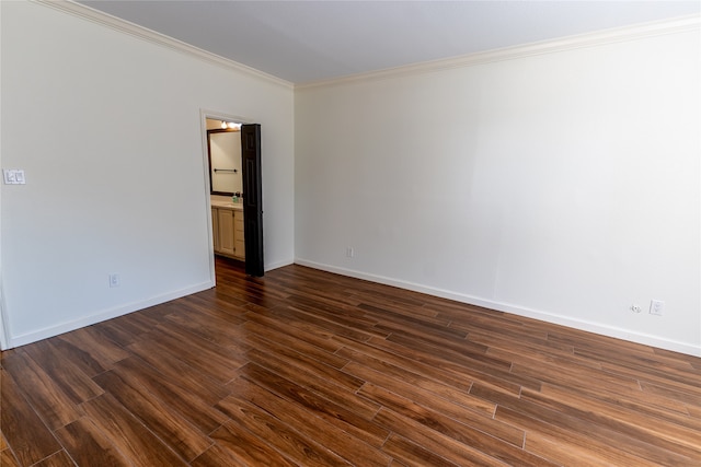 unfurnished room featuring dark wood-type flooring and crown molding