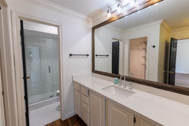 bathroom with vanity, crown molding, toilet, walk in shower, and wood-type flooring