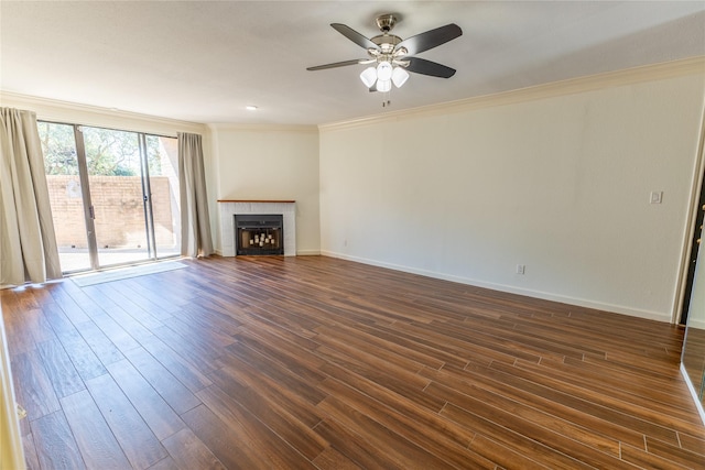 unfurnished living room with a fireplace, dark wood-type flooring, ceiling fan, and crown molding