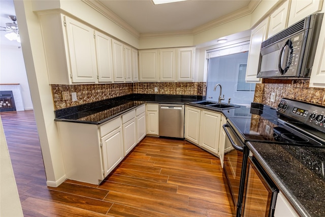 kitchen featuring white cabinets, decorative backsplash, sink, and black appliances