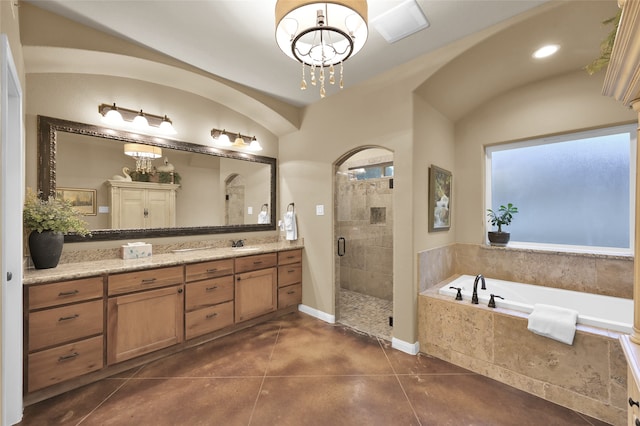 bathroom with vanity, tile patterned floors, an inviting chandelier, and separate shower and tub