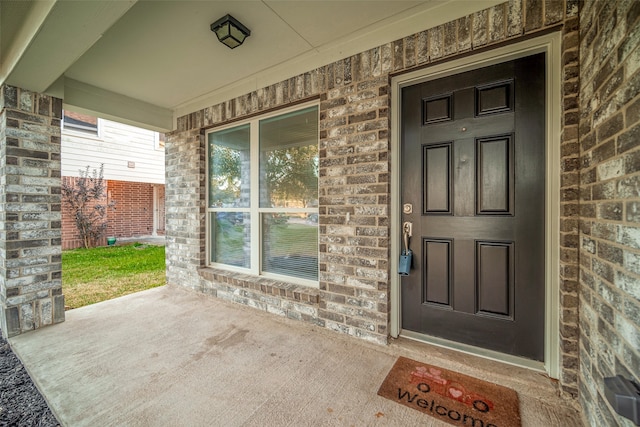 entrance to property featuring a porch