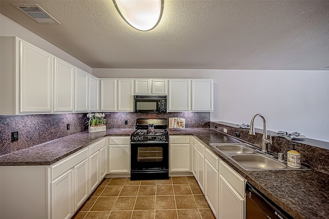 kitchen featuring sink, black appliances, white cabinetry, and decorative backsplash