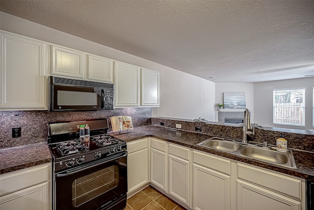 kitchen with sink, black appliances, a textured ceiling, and light tile patterned floors