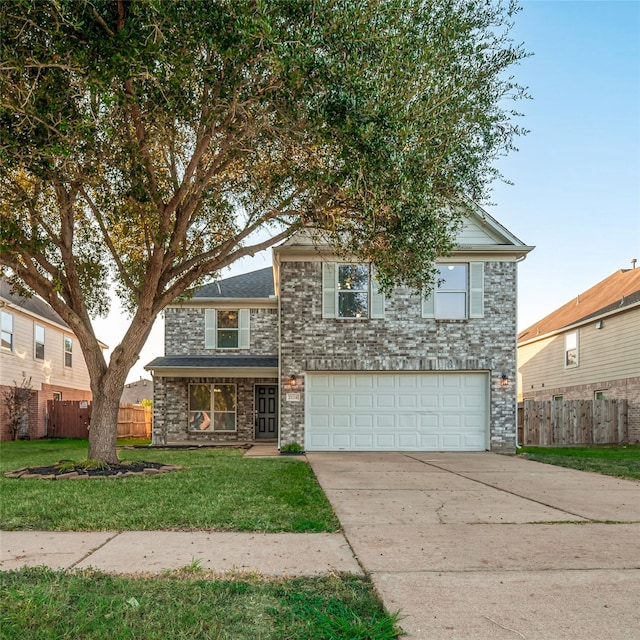 front facade featuring a front yard and a garage