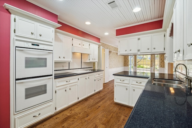 kitchen featuring sink, dark hardwood / wood-style flooring, white cabinetry, crown molding, and white double oven