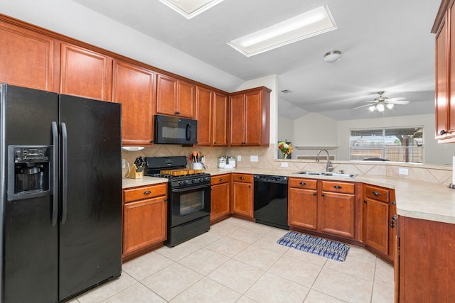 kitchen with black appliances, sink, kitchen peninsula, ceiling fan, and vaulted ceiling