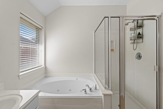 bathroom featuring vanity, separate shower and tub, and vaulted ceiling