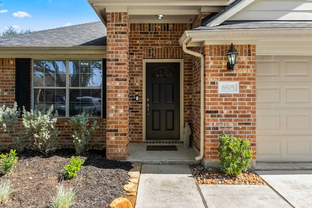 view of exterior entry featuring a garage