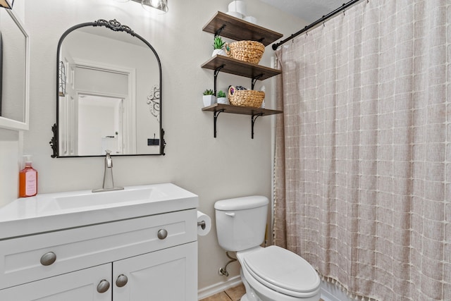 bathroom with toilet, a shower with curtain, vanity, and tile patterned flooring