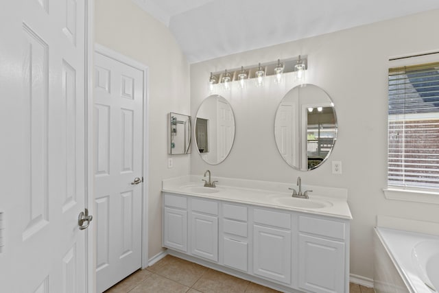 bathroom with vanity, a tub to relax in, and tile patterned floors