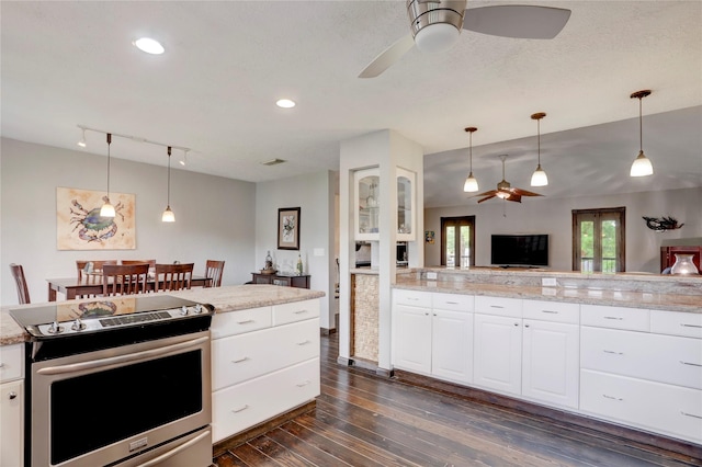 kitchen featuring white cabinets, stainless steel electric range, dark hardwood / wood-style flooring, and hanging light fixtures