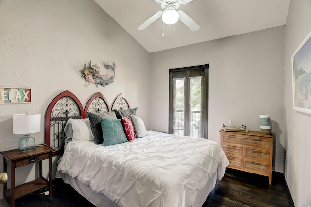 bedroom featuring ceiling fan, dark hardwood / wood-style floors, and lofted ceiling