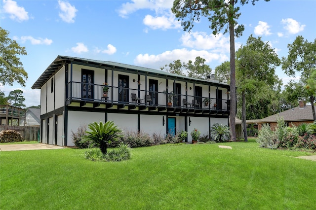 back of house featuring a yard and a garage