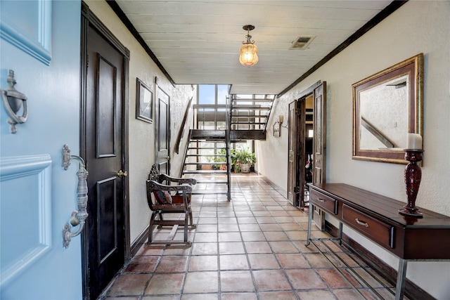 entryway featuring ornamental molding