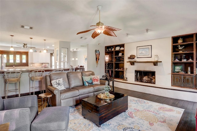 living room featuring hardwood / wood-style flooring and ceiling fan