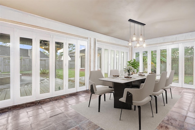 sunroom with a healthy amount of sunlight and a chandelier