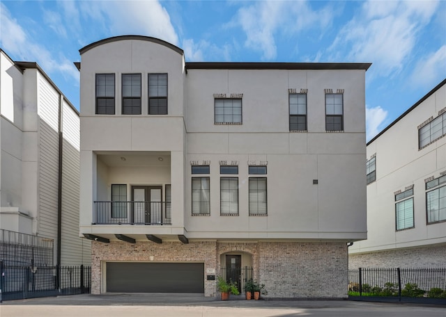 view of front of property with a balcony and a garage